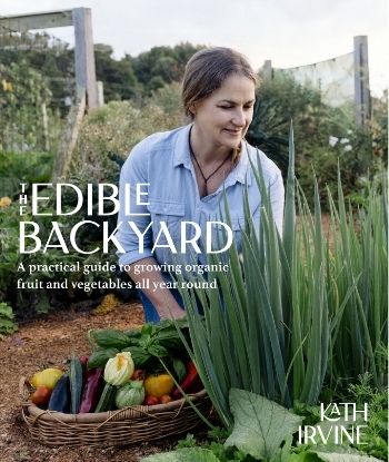 The Edible Backyard book cover with author Kath Irivne kneeling down gathering produce from her garden in a big basket while admiring her onions